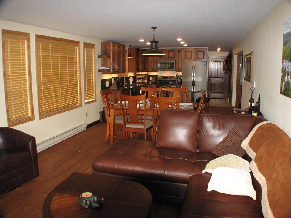 Great room with solid oak flooring throughout unit and picture window.