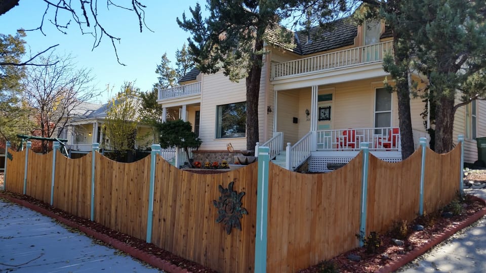 View of home and front porch from the sidewalk.