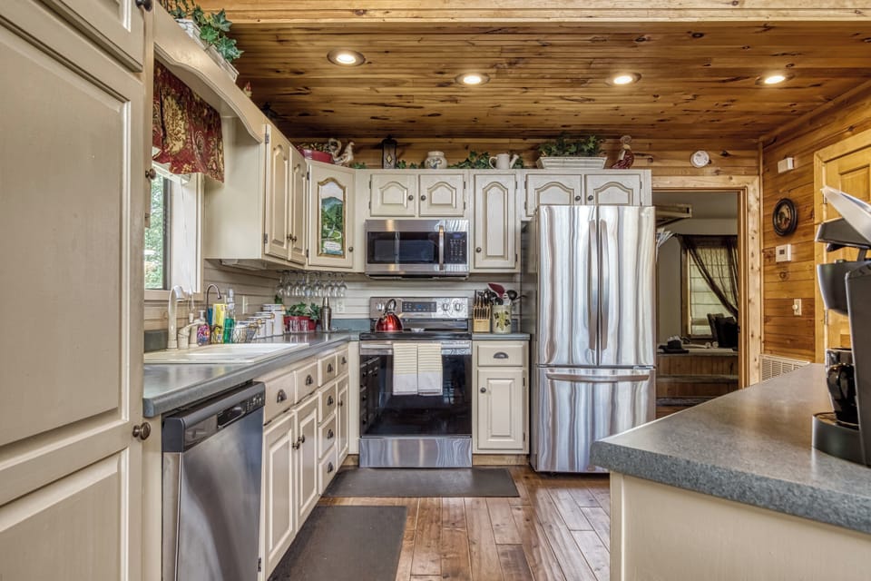 - Fully equipped kitchen with stainless steel appliances   - White cabinetry and wood accents for a warm cabin touch   - Everything you need for home-style cooking in the mountains
