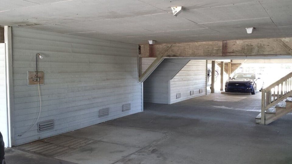 Stairs nearest to condo unit on the right.  Shower located near stairs.