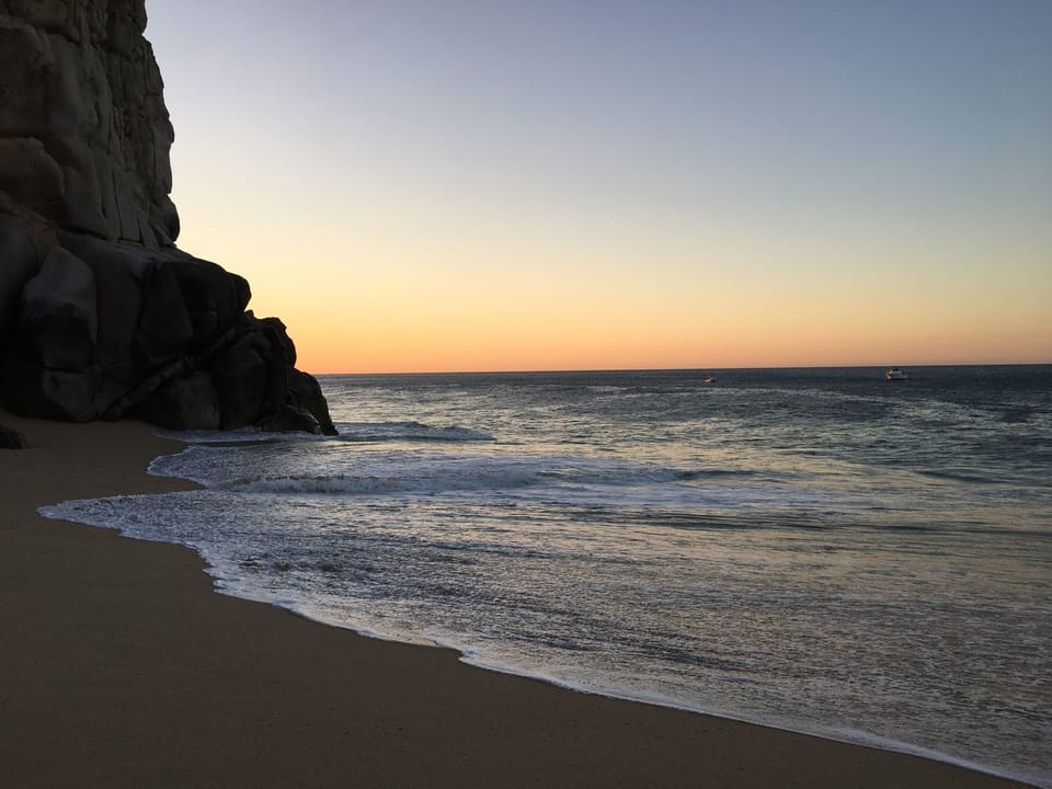 At sun rise looking at Land's End from the beach by the resort