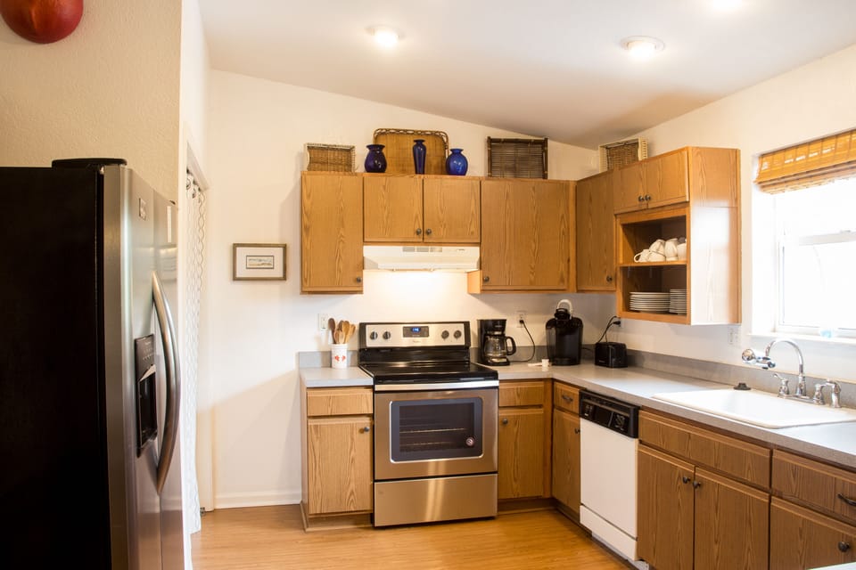 Bright, fully stocked kitchen—cook, gather, and make memories.