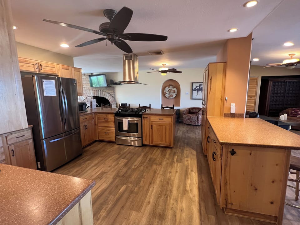 Open kitchen with stainless steel refrigerator and gas oven