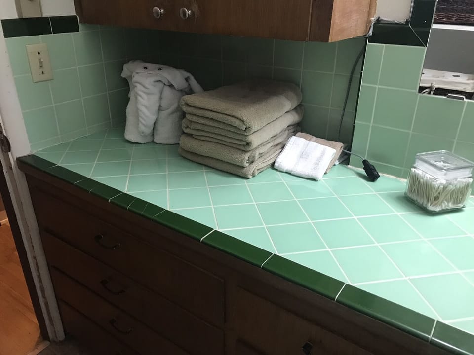 Bathroom with long counter space, 1950’s tile!