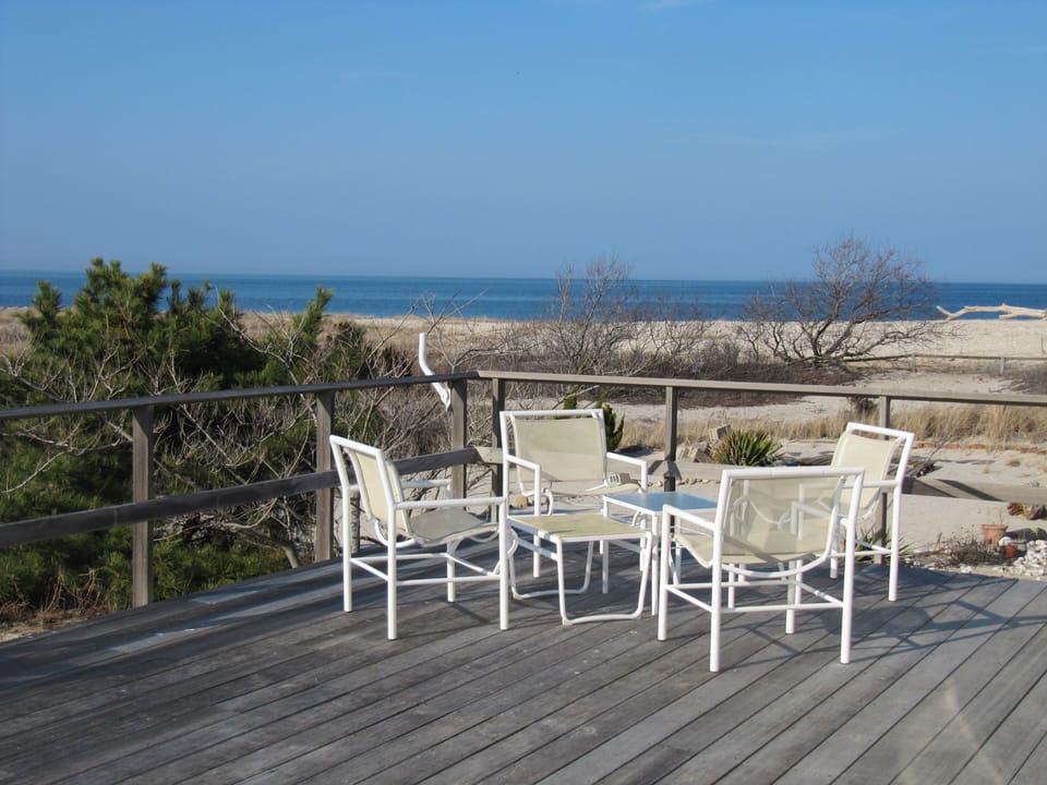 Large deck w/ 2 dining tables - largest readily seats 12 - and 2 lounge chairs