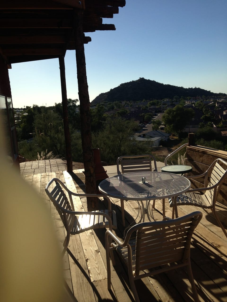 Hot tub just behind the table and chairs, dropped into the deck
