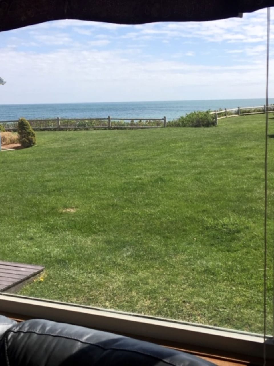 View from living room, manicured grass in front of cottage