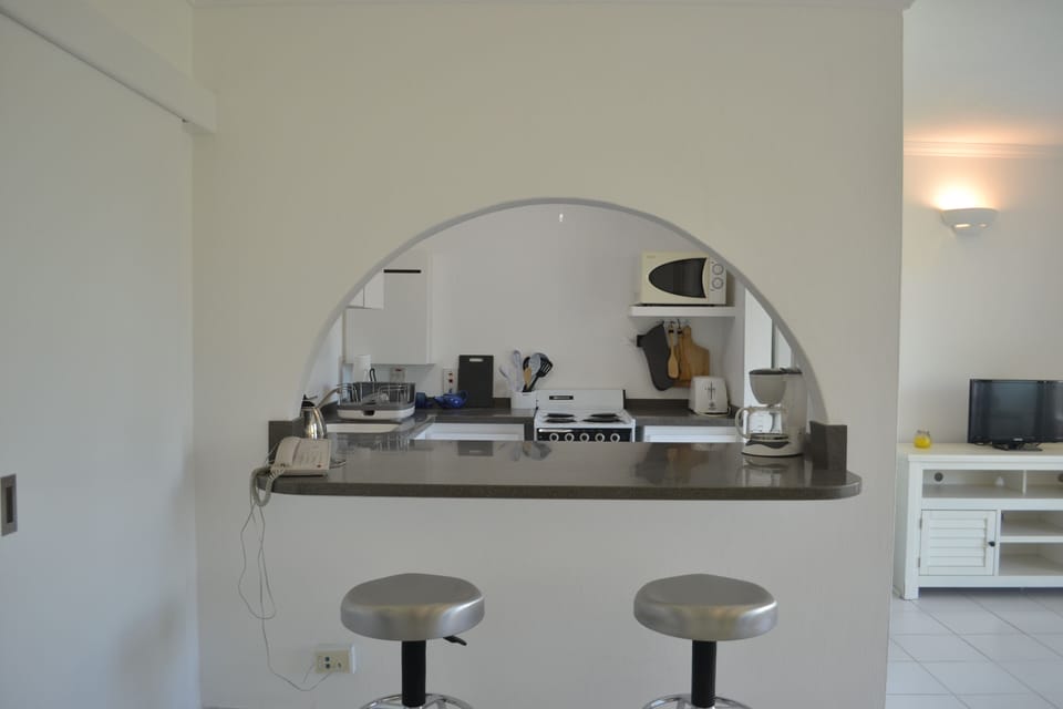 Breakfast bar and kitchen, viewed from sitting room