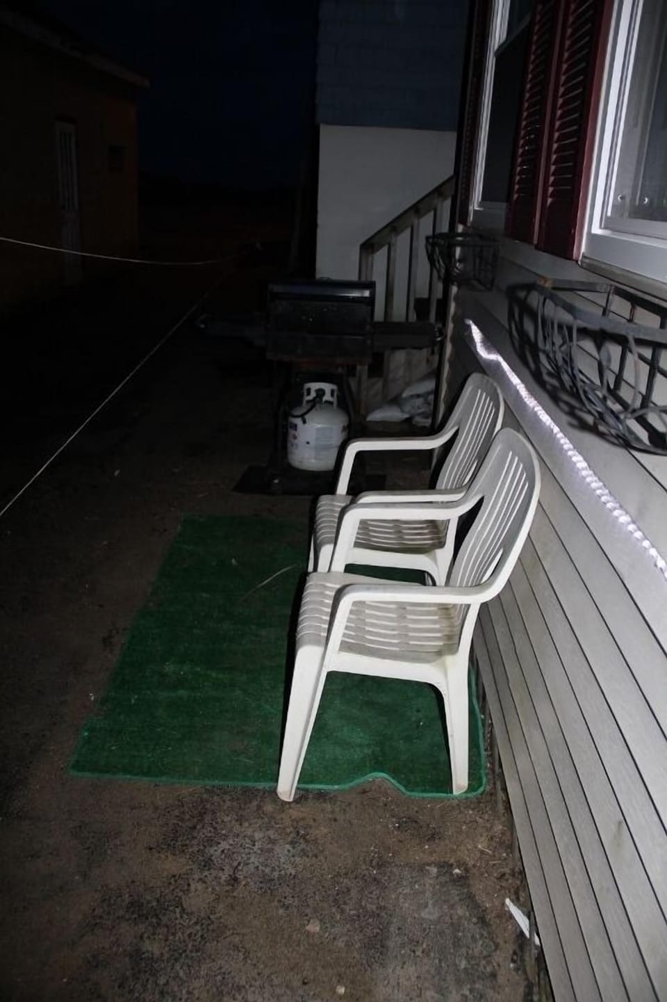 sorry its dark, small sitting area and gas grill 
