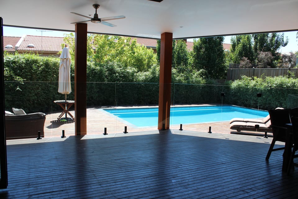 Enjoy a drink in the shade of the covered deck overlooking the pool