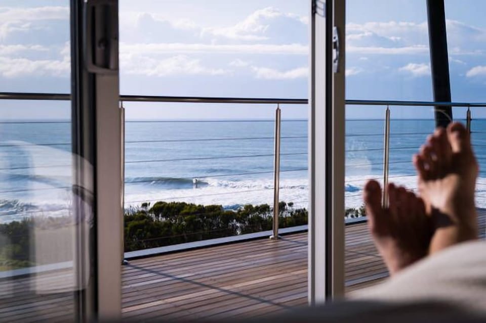 Watch the surfers, dolphins.....and whales when in season....