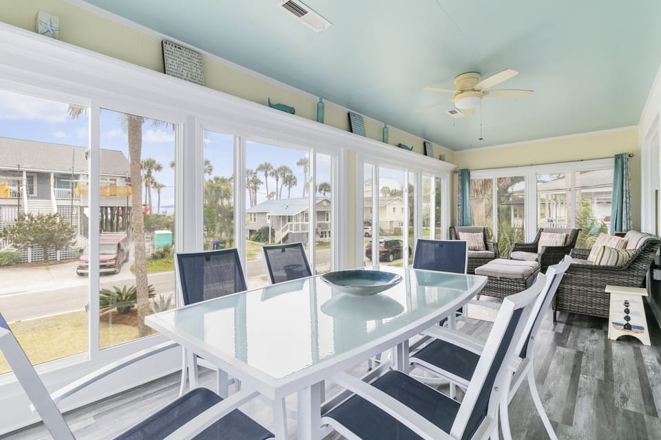 Upstairs sun room, facing the beach, off of the living room with plenty of seating to enjoy meals with your whole group.