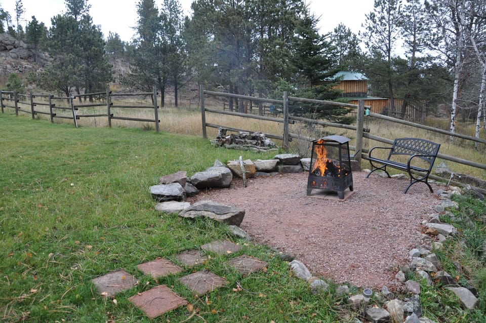 Outdoor fire pit with barn in background