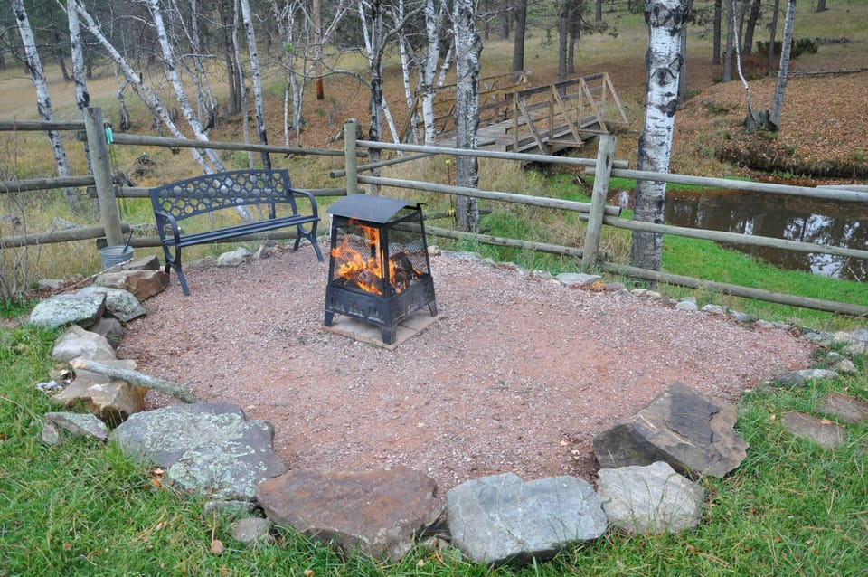 Outdoor fire pit with bridge in background