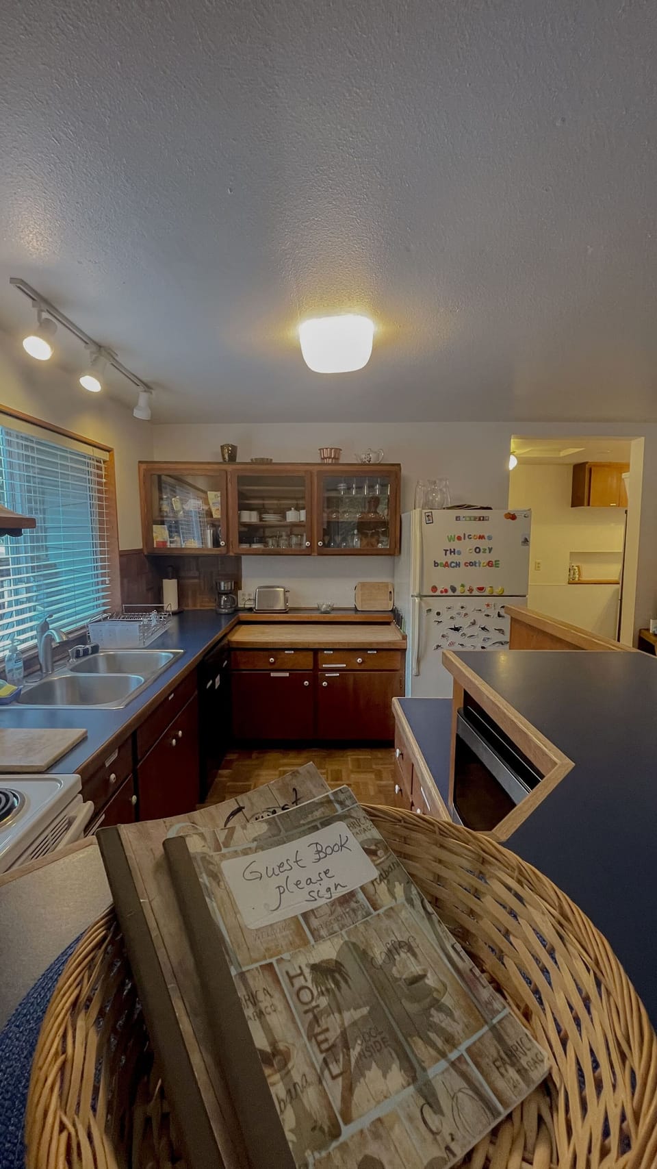 View of kicthen from dining room with guest books featured.