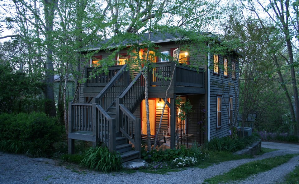 Entry deck above covered porch off lower bedroom, parking left, driveway right