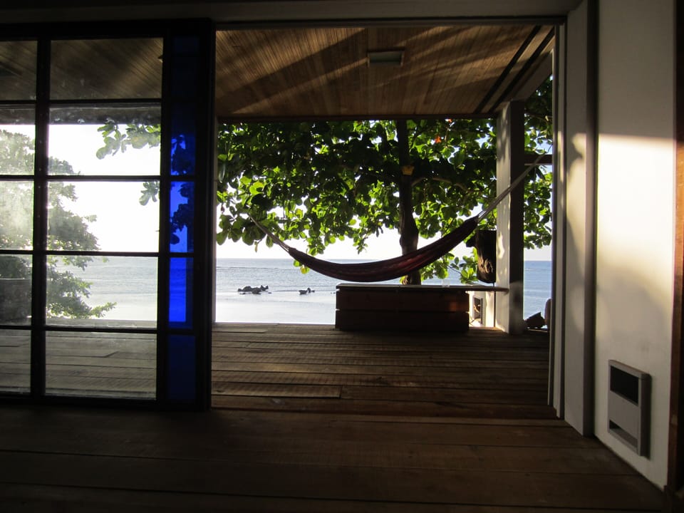 sliding doors open the living room to the ocean