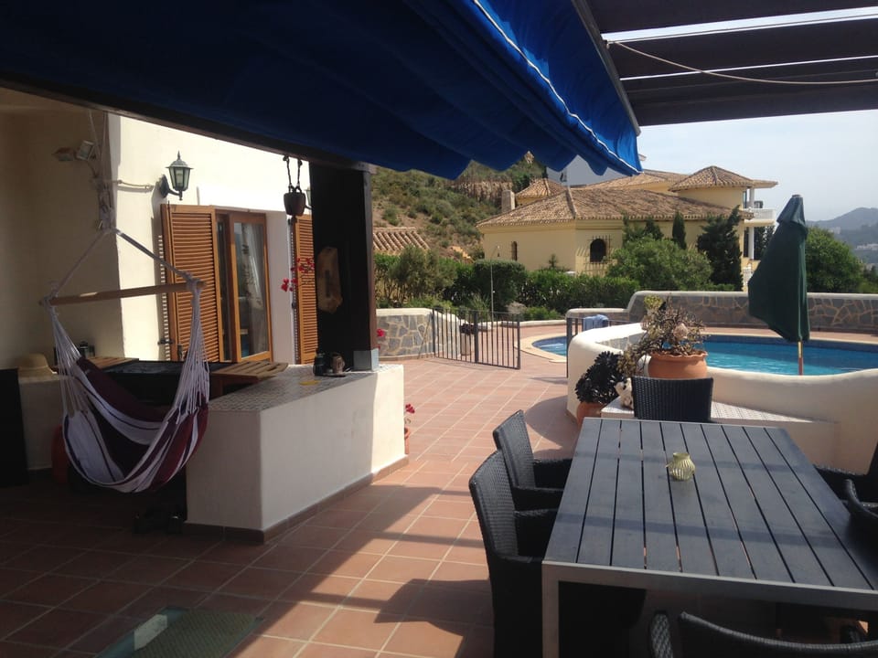 Patio area with seating and parasol.