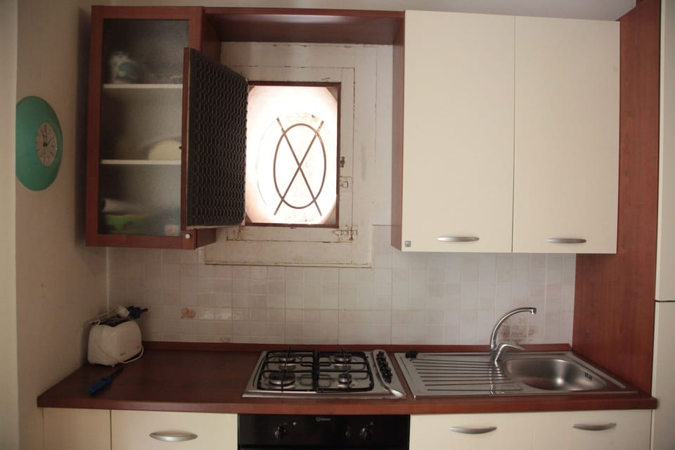 Fully equipped kitchen with oven and toaster.