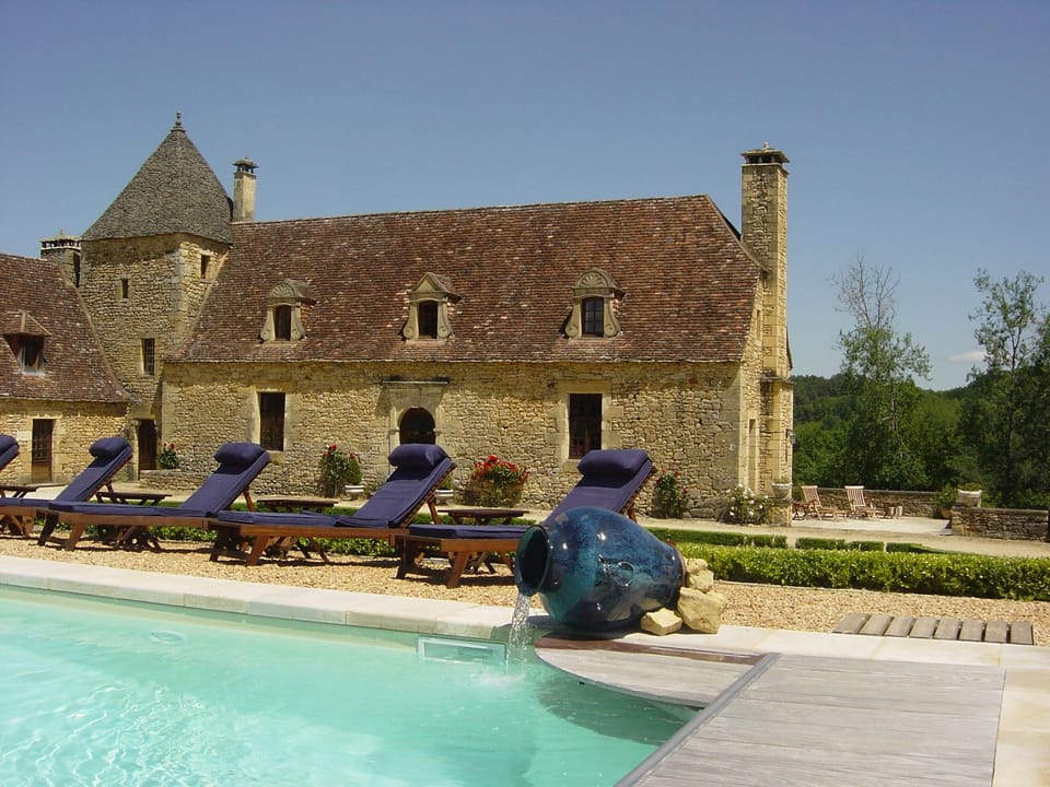 A large heated swimming pool with beautiful Chinese urns with running water.