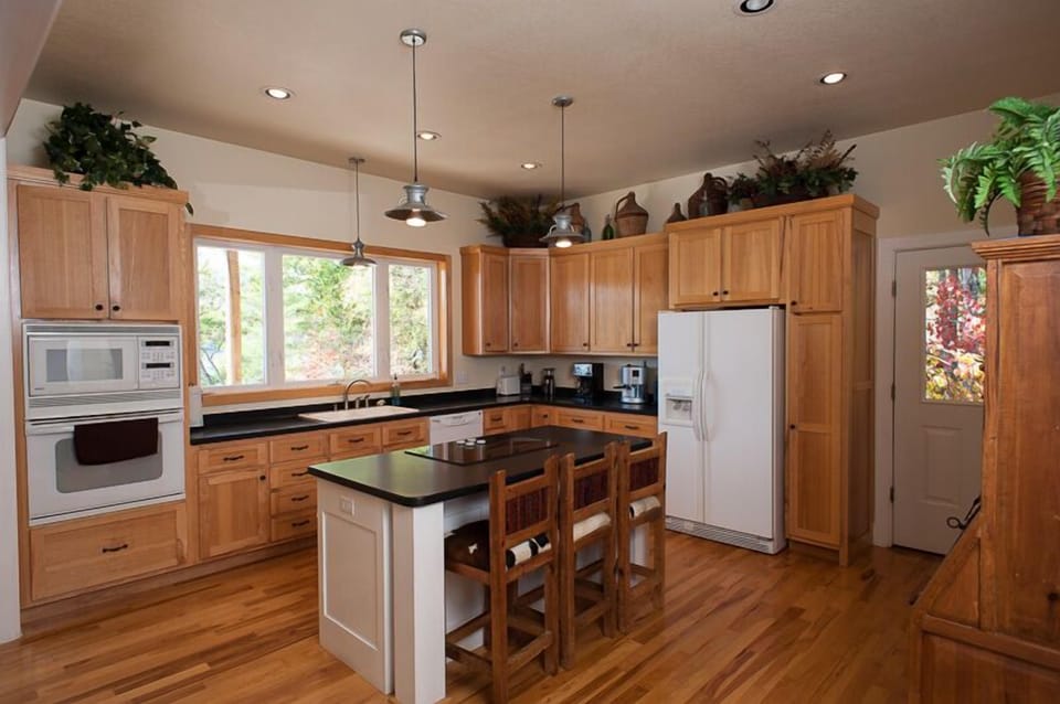 Fully stocked kitchen with island/bar, range, wall oven, microwave, coffee, etc.