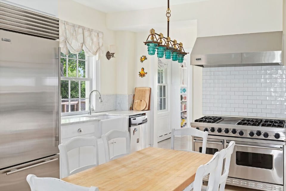 Updated kitchen with marble counter tops and stainless steel appliances 