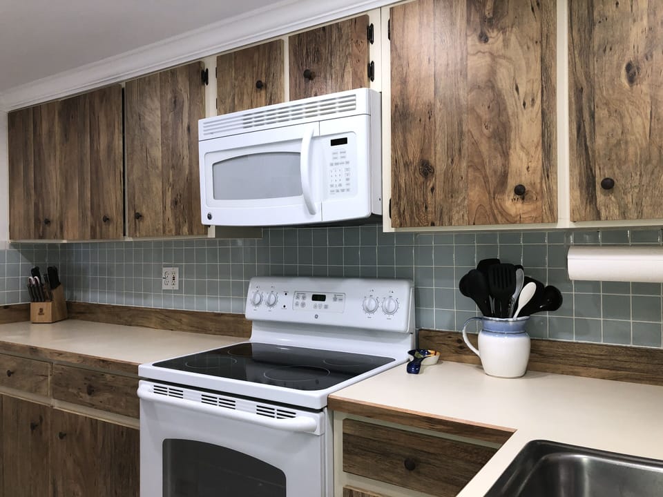 Microwave and Oven. Cabinets fully stocked for cooking/eating in.