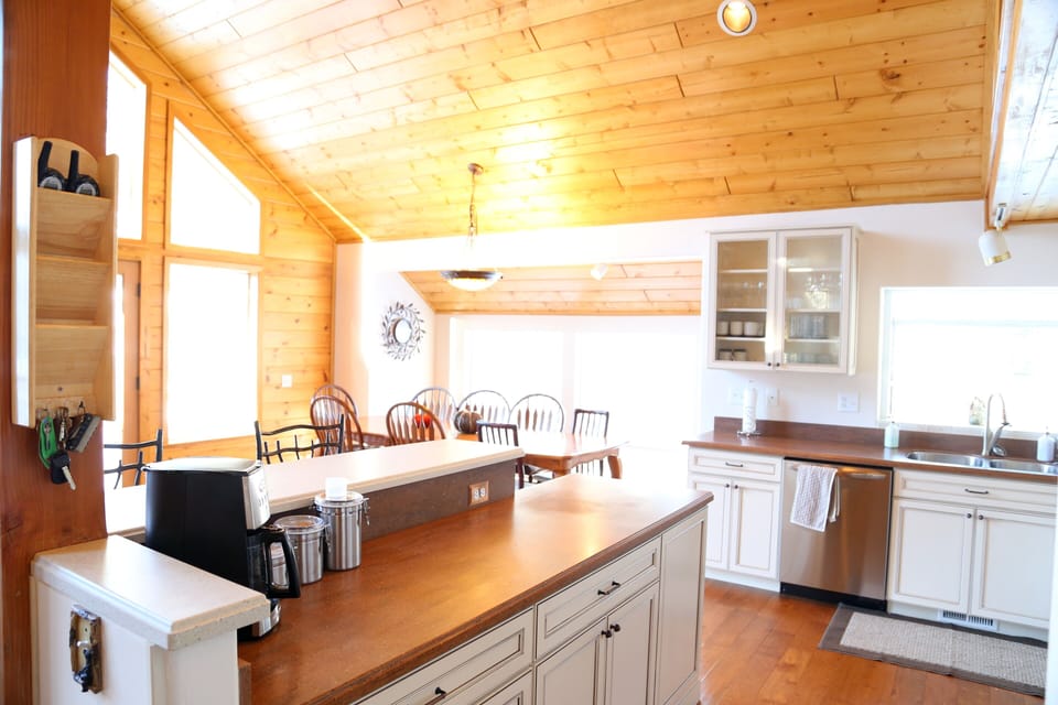 Kitchen, Showing Coffee Bar/Island.  Background Shows Dinning Table That Seats 8