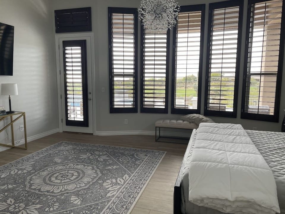 Primary bedroom with view of patio and golf course.  Separate entrance to patio.