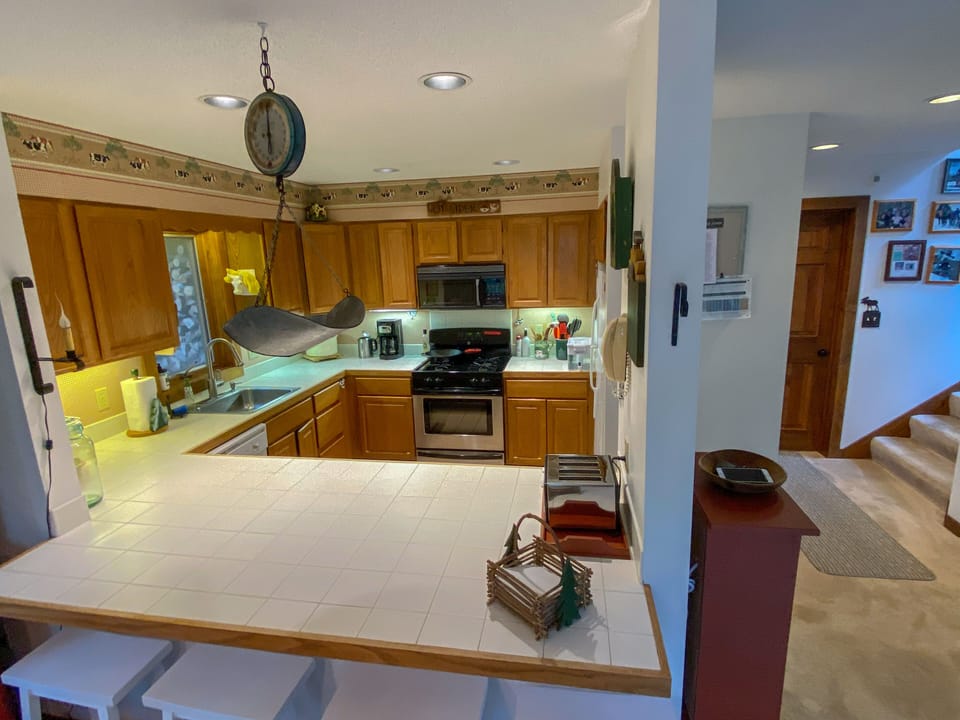 Open kitchen with stove, microwave, dishwasher, coffee maker and Keurig