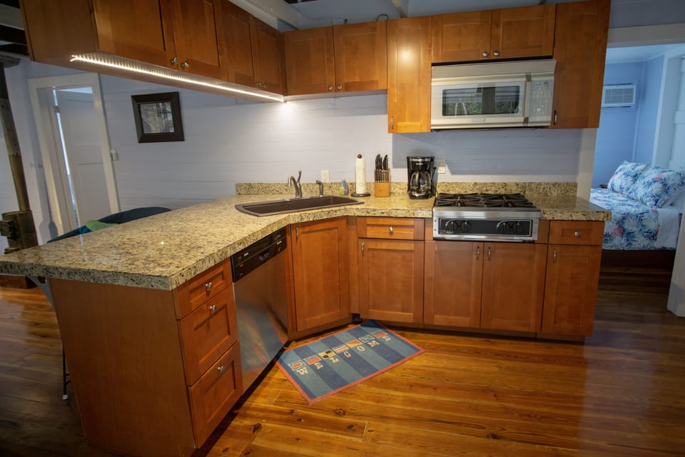 Fully equipped kitchen with stovetop, convection microwave oven, dishwasher
