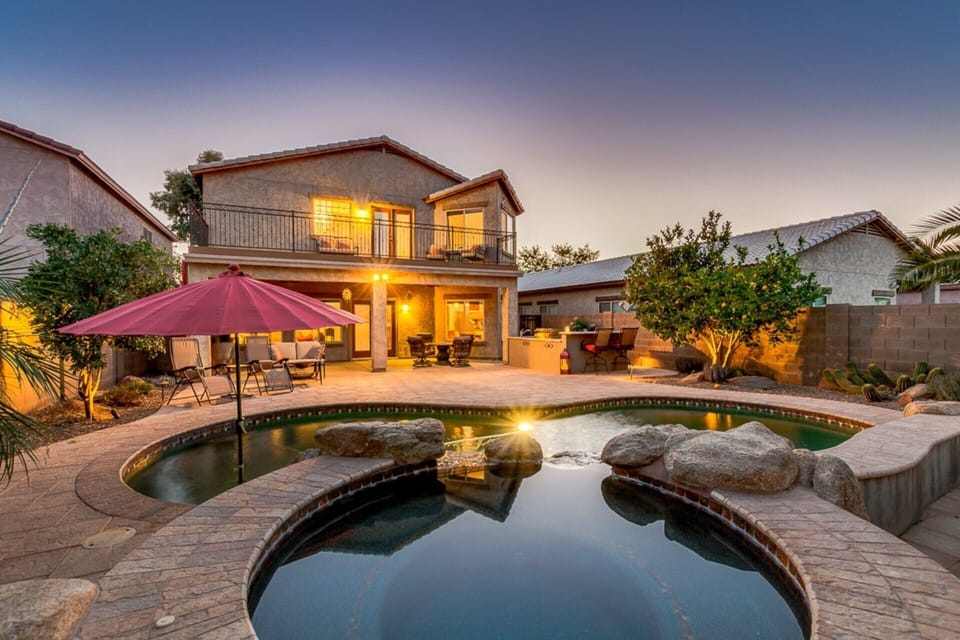 The GORGEOUS, private pool, spa and view of back yard including outdoor kitchen.