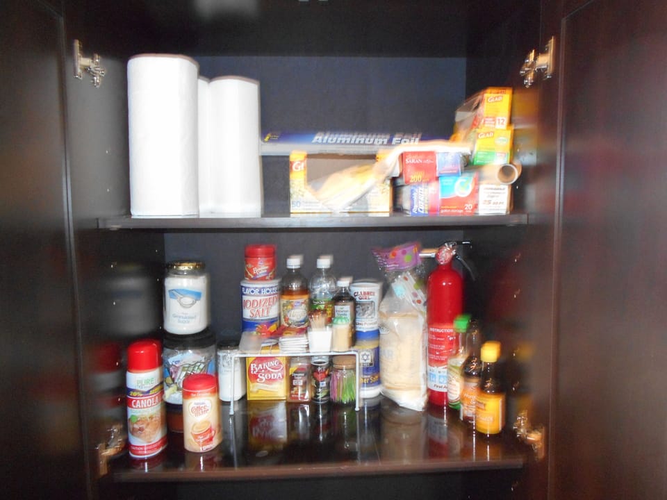 Pantry well stocked with staples, paper products, spices

