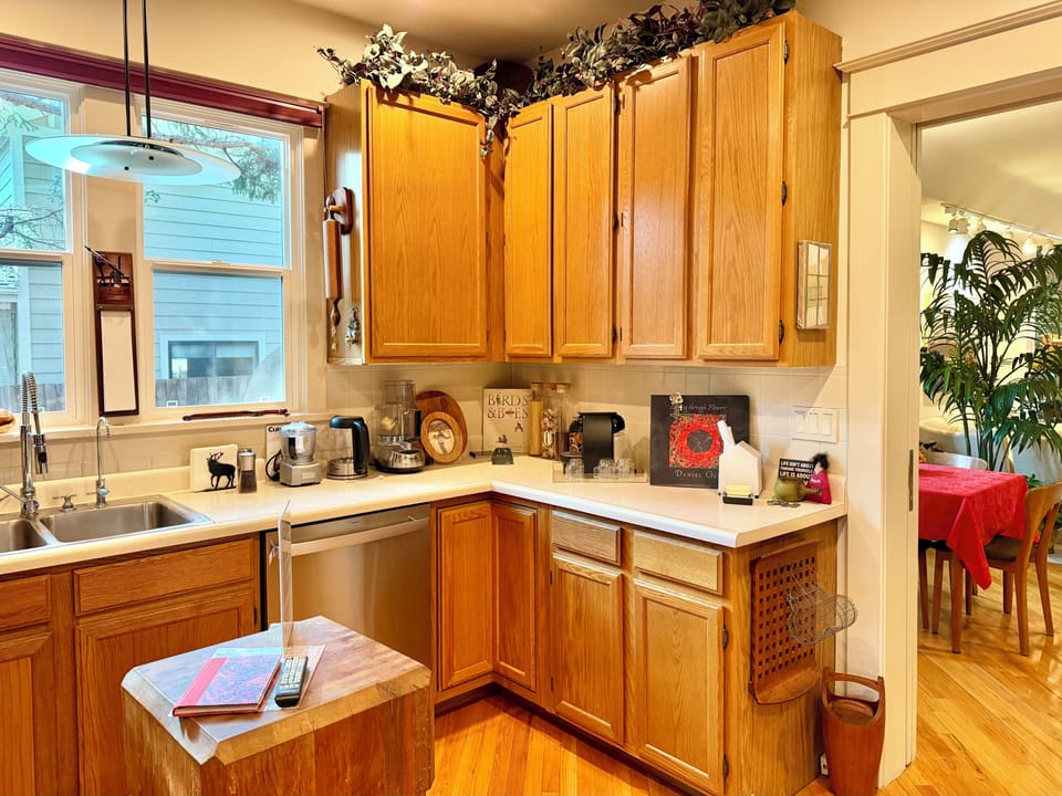 Kitchen with dishwasher, microwave, toaster oven and Nespresso coffee maker.