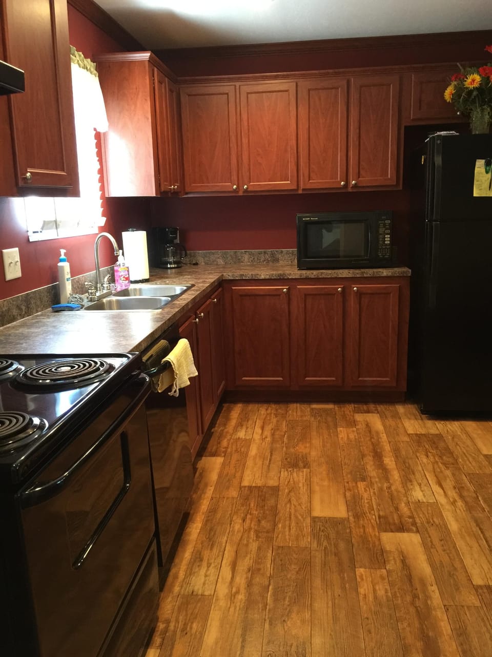 Kitchen Electric range, Microwave and Dishwasher. Dishes and cookware stocked.