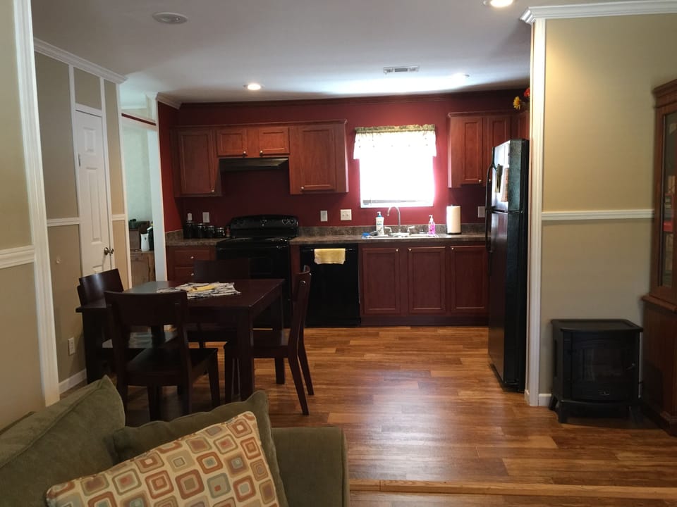 Kitchen.  Table with seating for four.  Refrigerator with ice maker, dish washer