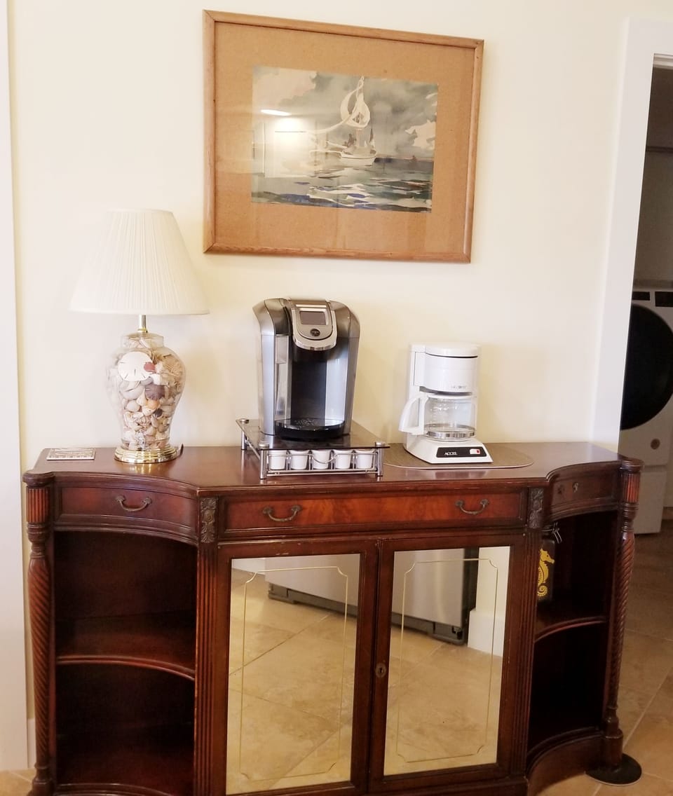 The kitchen has a coffee station with a Keurig and coffee maker