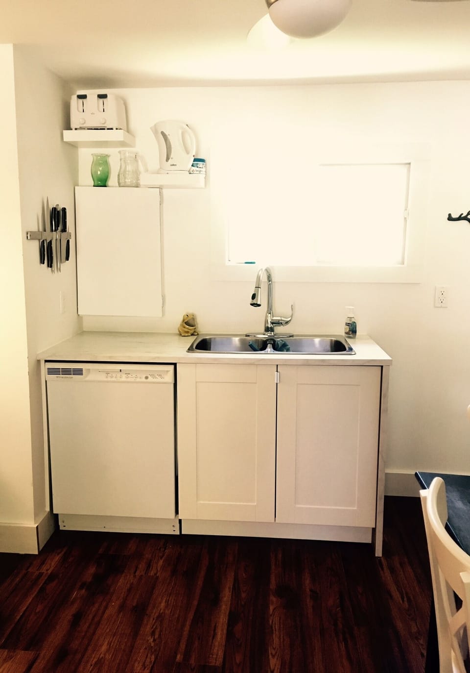Basic but serviceable kitchen with dishwasher, stove, & large fridge (in foyer).