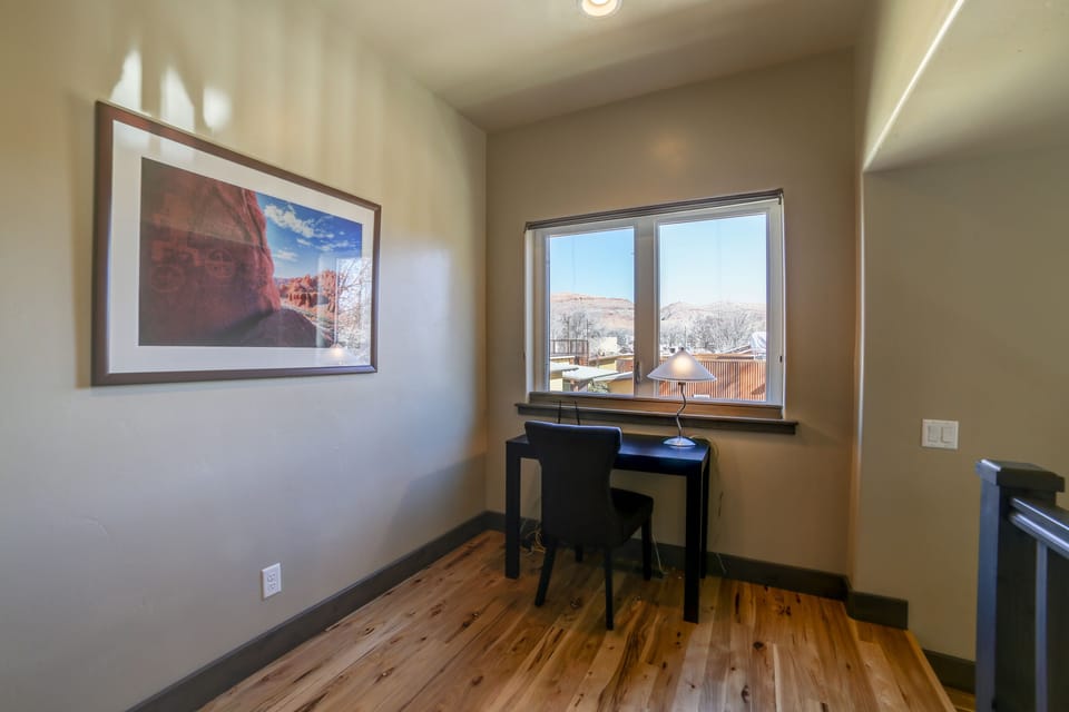 Loft at the top of the stairs with a nice work area.