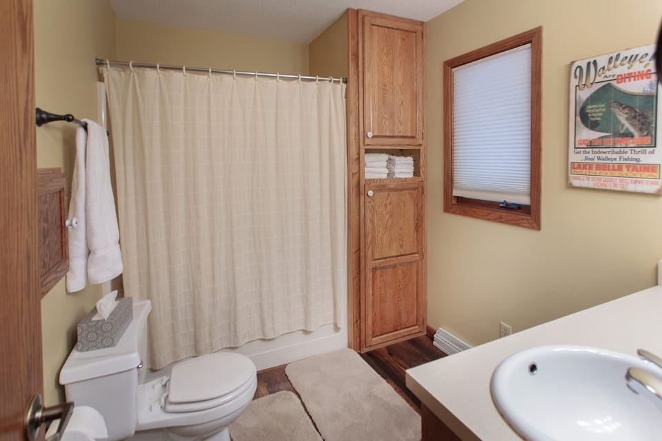 Main floor bathroom with bathtub and shower.