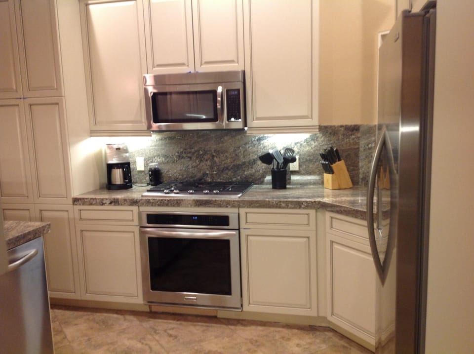 Granite counters separating stove cook top and oven.
