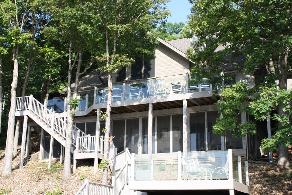 House from dock, martini deck closest, screened central deck, open top deck.