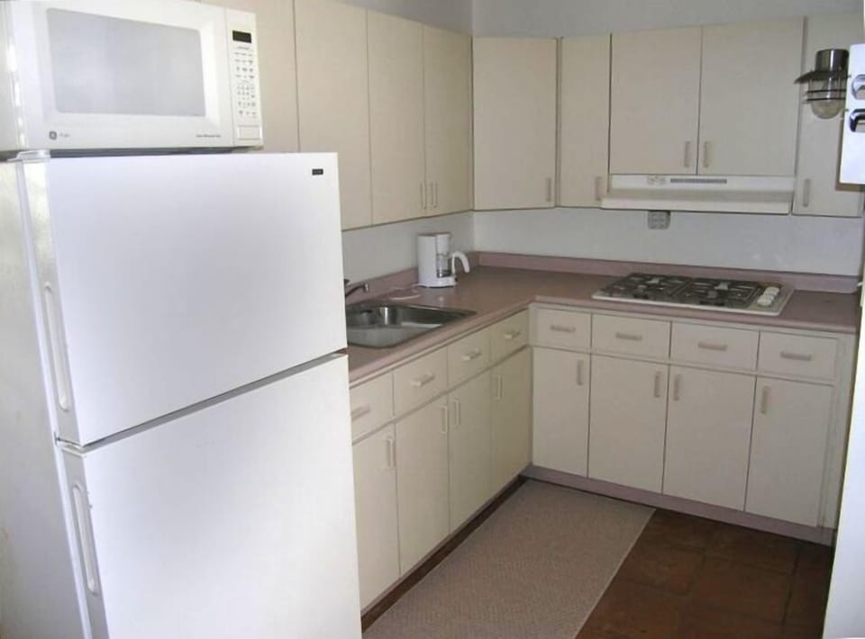 Kitchen with stovetop and cookware. 