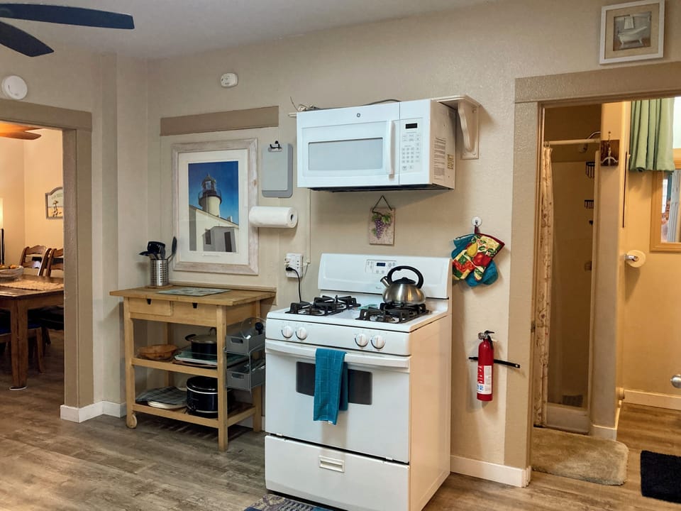 Spacious kitchen with gas stove and microwave
