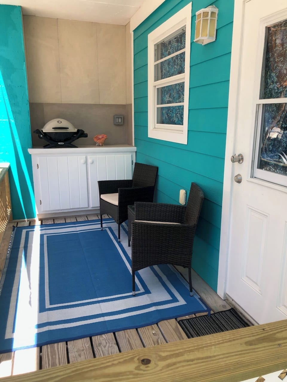 Private covered patio with barbecue and seating
