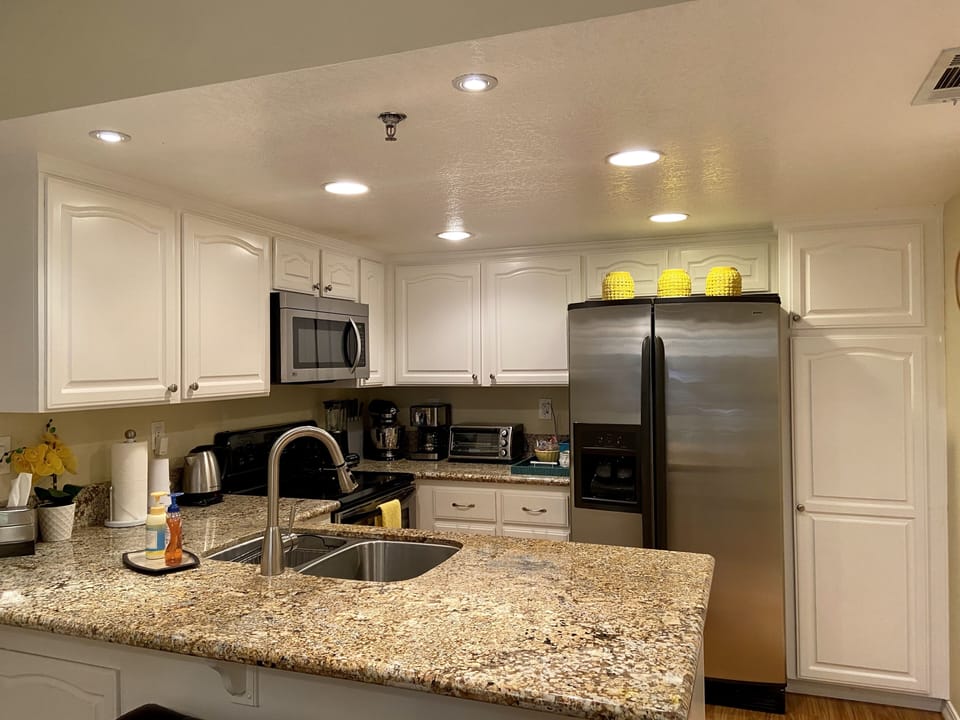 Our kitchen, complete with stainless appliances, and side-by-side refrigerator. 