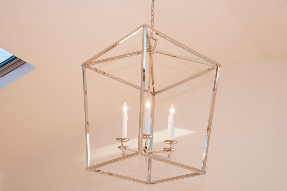 Oversized chandelier above dining table.