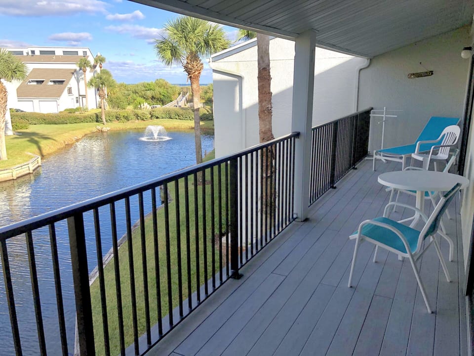 Balcony seating and view of lagoon, beach boardwalk and ocean over the dunes 