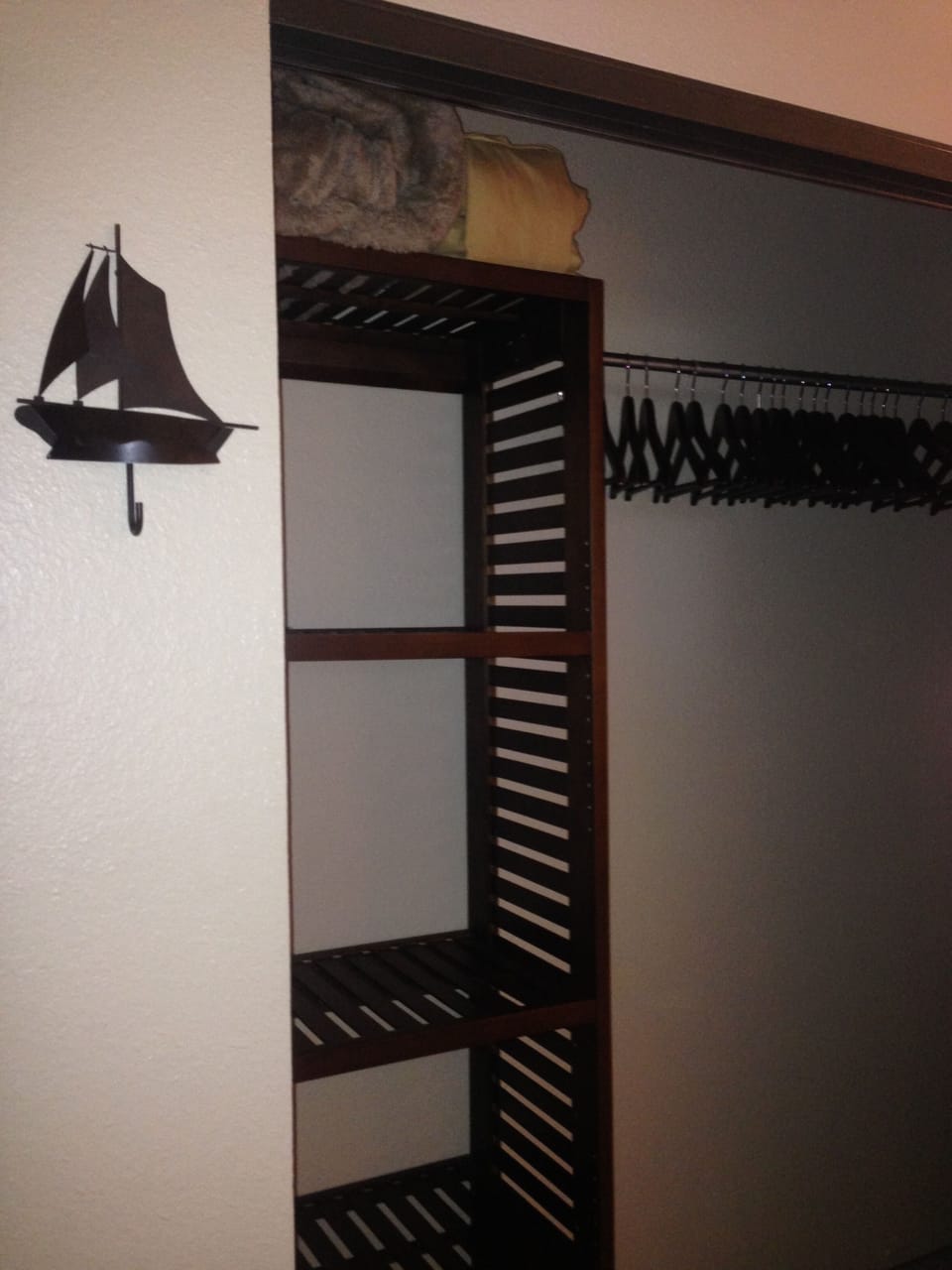 Closet has mohogany vented shelving for 2 to store your clothes after unpacking