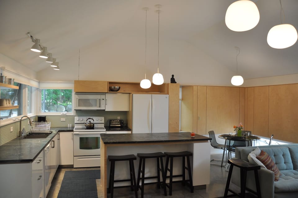 Kitchen with oven, microwave, dishwasher,  toaster oven, and full sized  fridge.